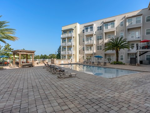 a large swimming pool in front of an apartment building